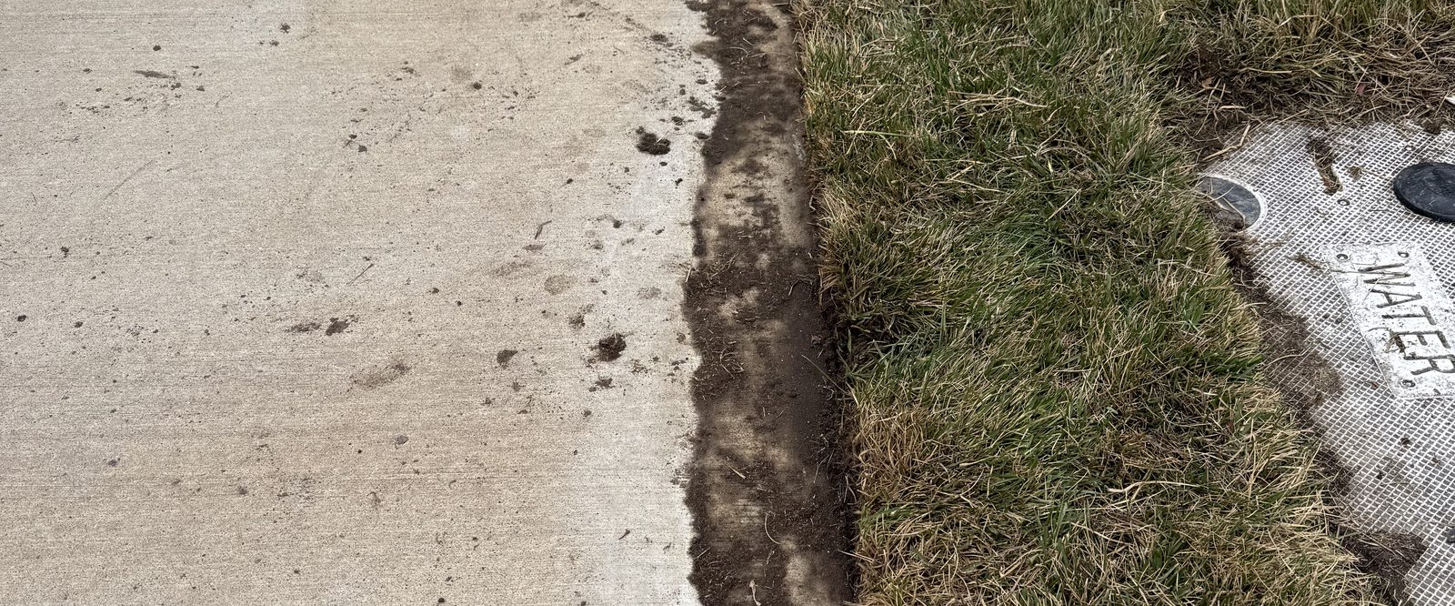 Freshly edged lawn line along a sidewalk maintained by Sierra Lawn Co. in Sparks, Nevada