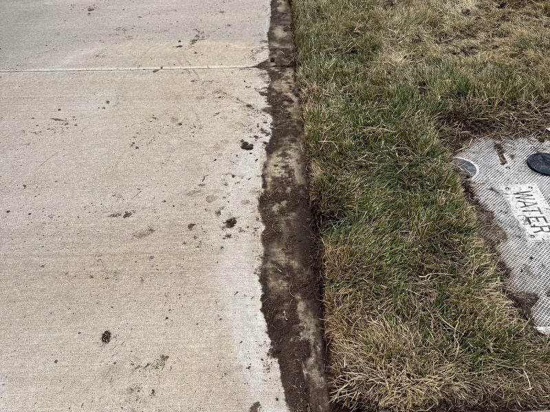 Freshly edged lawn line along a sidewalk maintained by Sierra Lawn Co. in Sparks, Nevada