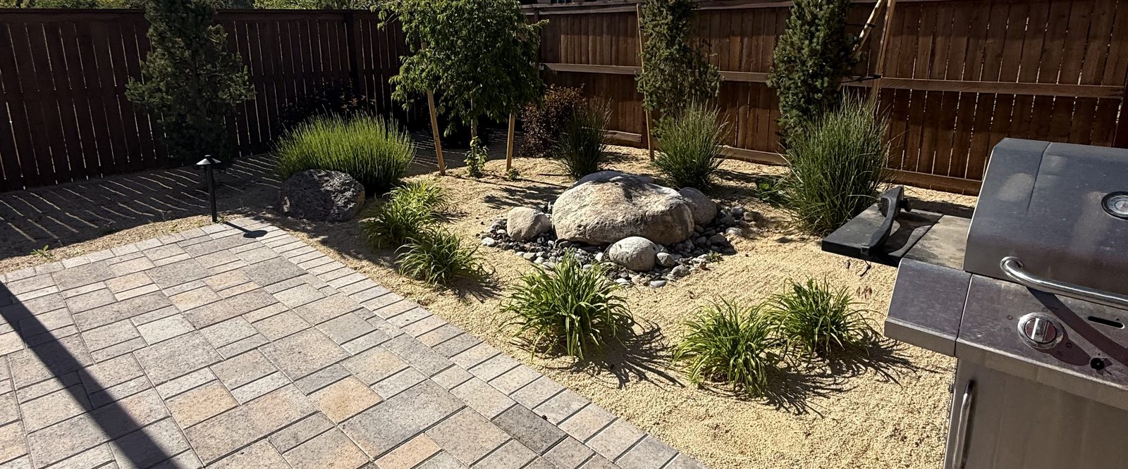 Backyard patio and xeriscape beds reset by Sierra Lawn Co. spring cleanup in Sparks, Nevada