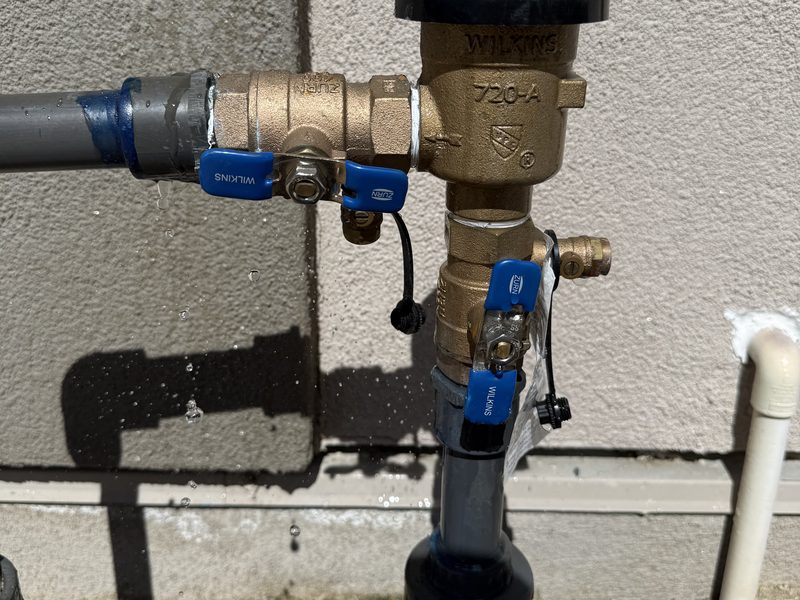 Leaking backflow preventer valve being repaired by Sierra Lawn Co. in Sparks, Nevada